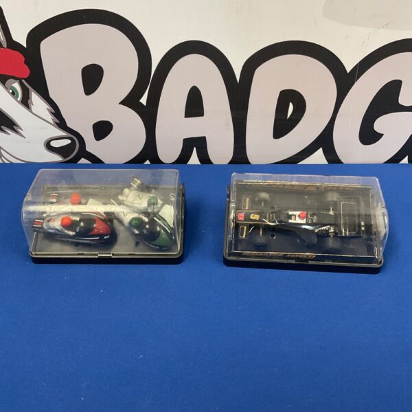 Vintage Scalextric Lotus 77 racing car in display case.