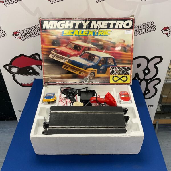 Vintage Scalextric Mighty Metro racing set with two cars.