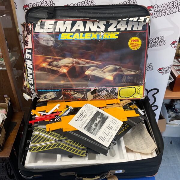 Vintage Scalextric track set and cars inside a suitcase.
