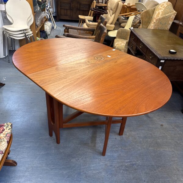 Vintage Scandinavian teak gateleg table in a room setting.