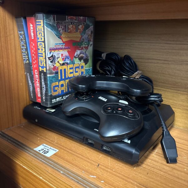 Sega Megadrive console with controllers and game cartridges.
