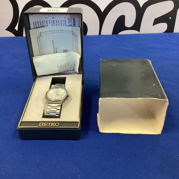 Vintage Seiko wristwatch with silver dial and stainless steel bracelet.