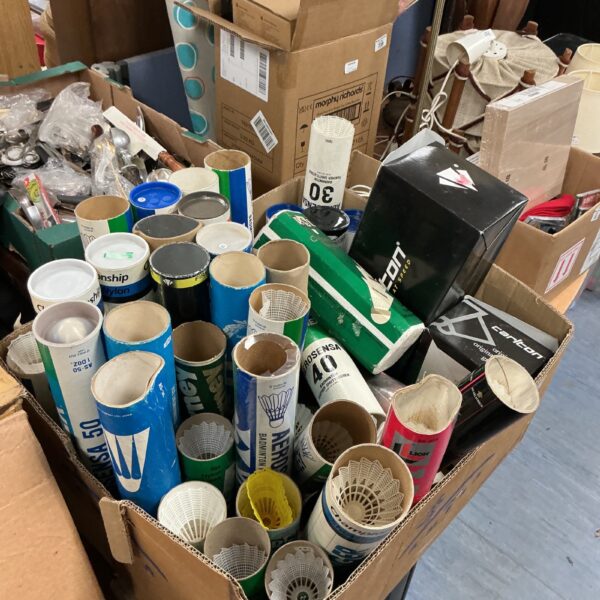 Mixed lot of shuttlecocks in opened and unopened boxes.