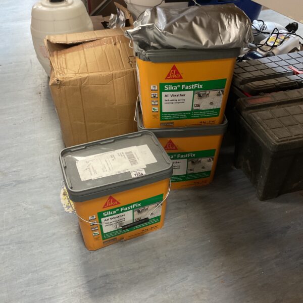 Three buckets of Sika Fastfix all-weather jointing compound for paving.
