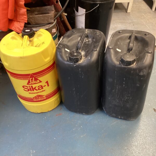 Three tubs of Sika waterproofer sealant for construction and DIY projects.