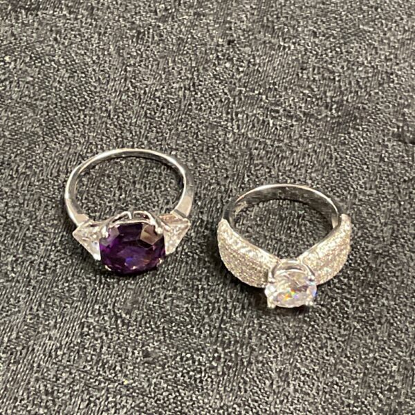 Silver ring set featuring an amethyst and white stones.