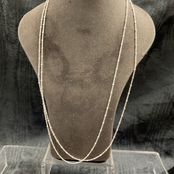 Two delicate 925 silver ball link necklaces on a display stand.