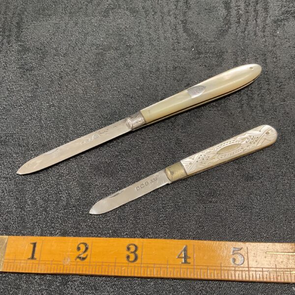 Antique silver fruit knives with mother of pearl handles.