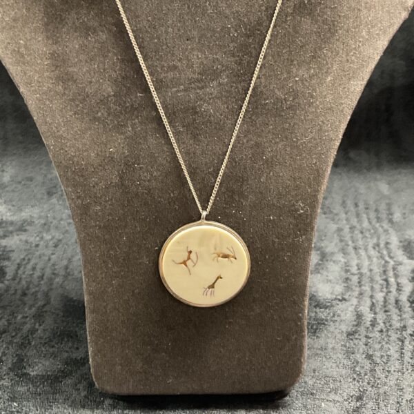 Silver pendant featuring gazelle and giraffe silhouette on silver chain.