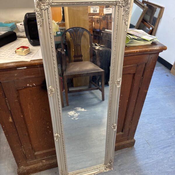 Ornate silver gilt framed mirror for wall decoration.