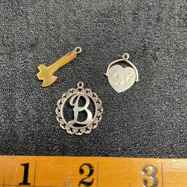 Vintage silver, heart, and amber pendant lot for collectors.