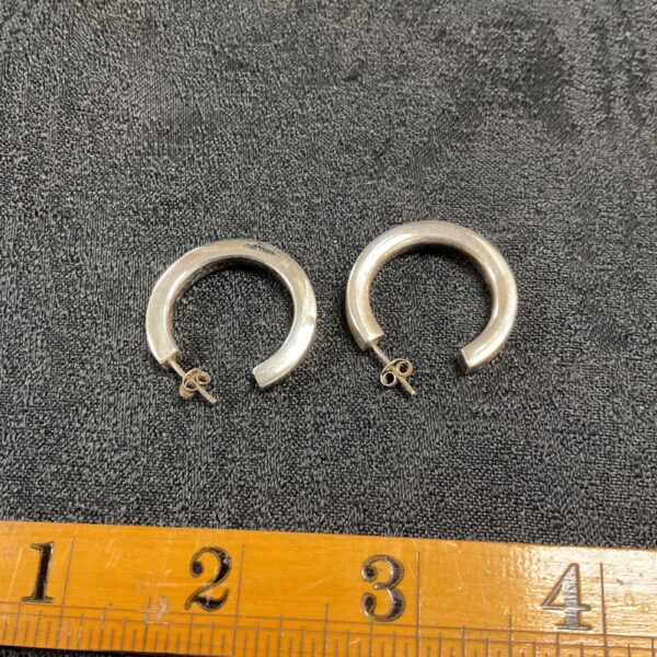 Close-up of 925 silver hoop earrings with a polished finish.