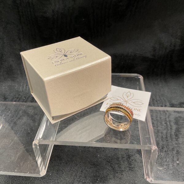 Silver meditation ring with spinning energy stone for anxiety relief.