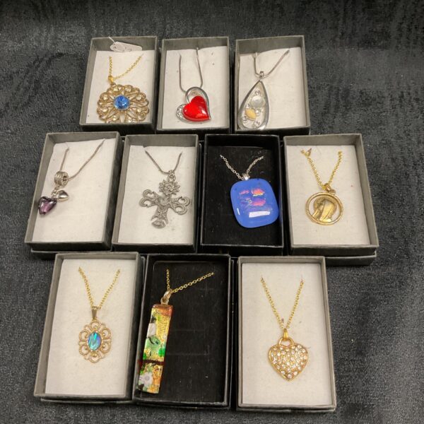 Silver pendant necklace with a floral design.