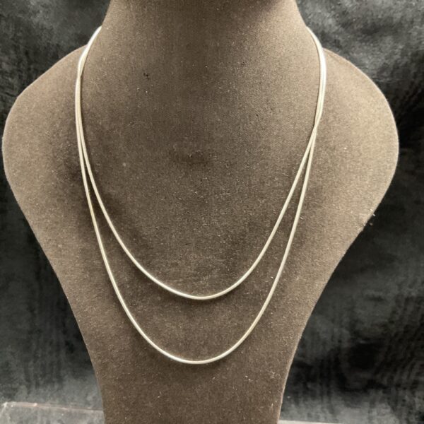 Pair of delicate silver snake chain necklaces, 16 and 18 inches long.