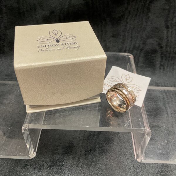 Silver spinner ring with energy stone and rotating bands.