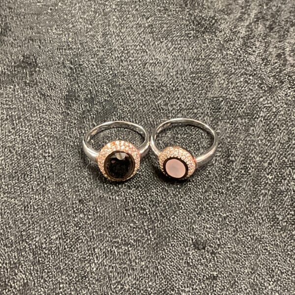 Pair of silver rings with contrasting black and white stones.