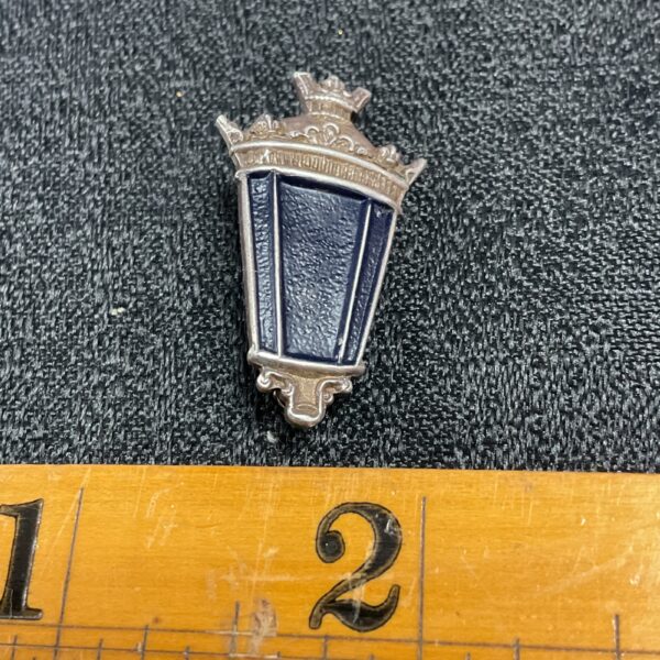 Vintage silver street lamp brooch with blue enamel detail.