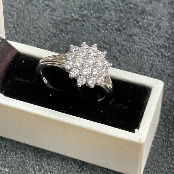 Silver whitestone cluster ring size O, sparkling floral design.