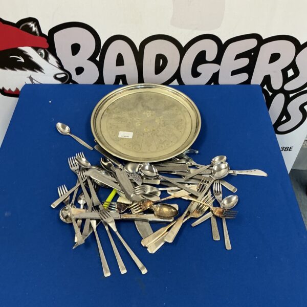 Vintage silverplate tray with matching cutlery set on display.