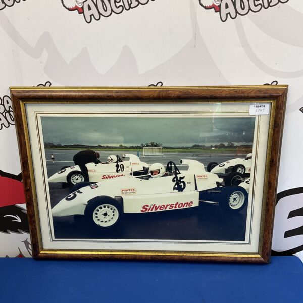 Framed vintage Silverstone Formula One race photograph for collectors.