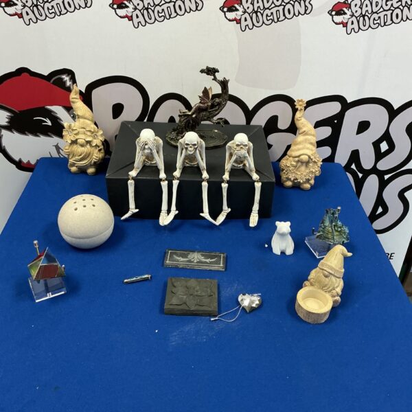 A lot of three skeleton ornaments depicting hear, speak, and say no evil.