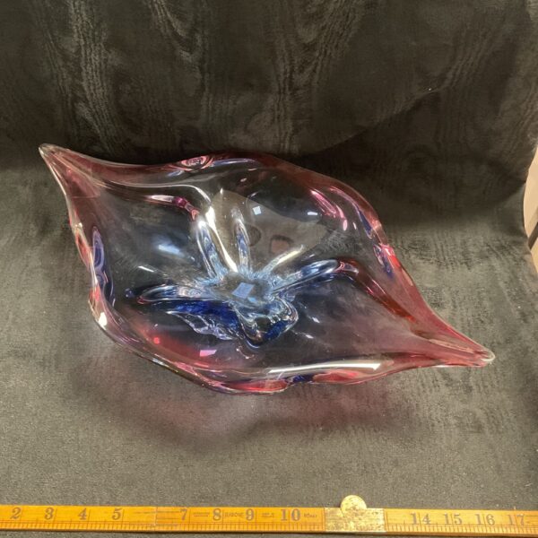 Pink and periwinkle Sklarna Chribska glass centrepiece on display.