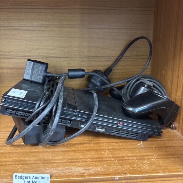 Front view of a Sony PS2 Slim console with controller.