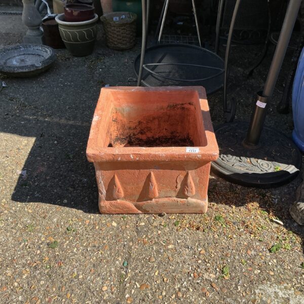 Rustic square terracotta planter for garden plants.