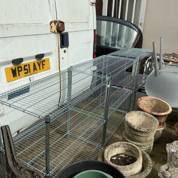 Three stainless steel storage racks for versatile storage solutions.