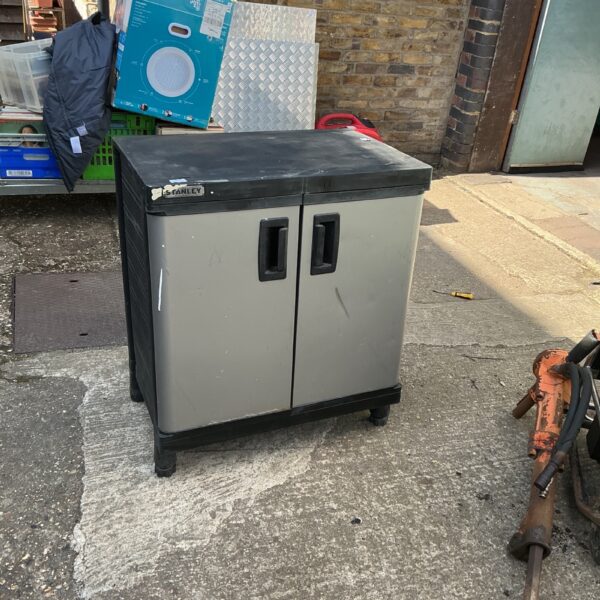 Front view of a grey Stanley garden tool box with dual doors.