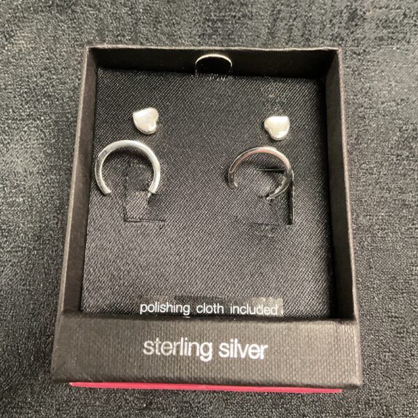 Close-up of two pairs of sterling silver stud earrings.