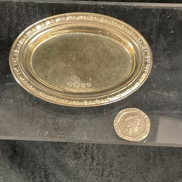 Antique sterling silver pin dish with floral embossed detail.
