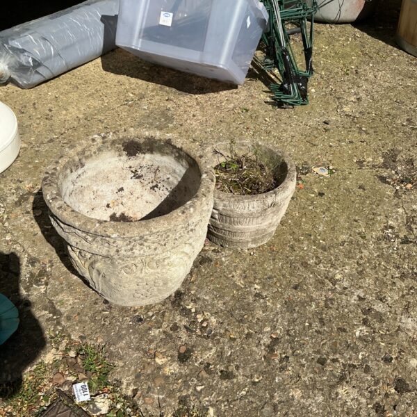 Two weathered stone effect garden planters for outdoor use.