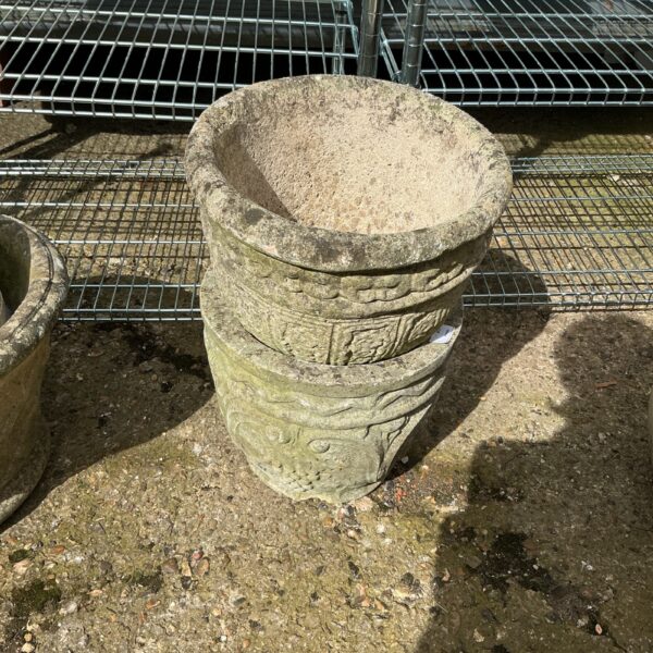 Rustic stone effect garden planter for outdoor display.