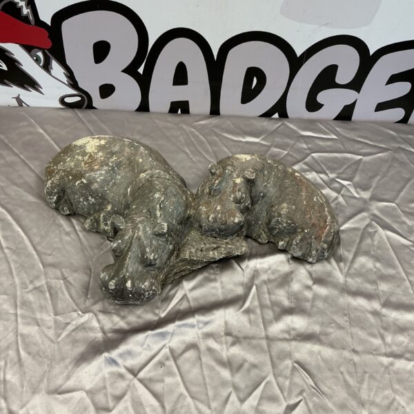 Weathered stone hippo garden ornament for outdoor display.