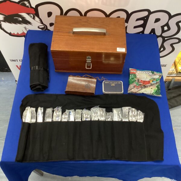 Storage box with Lego Creator set, cutlery, and multi tool.