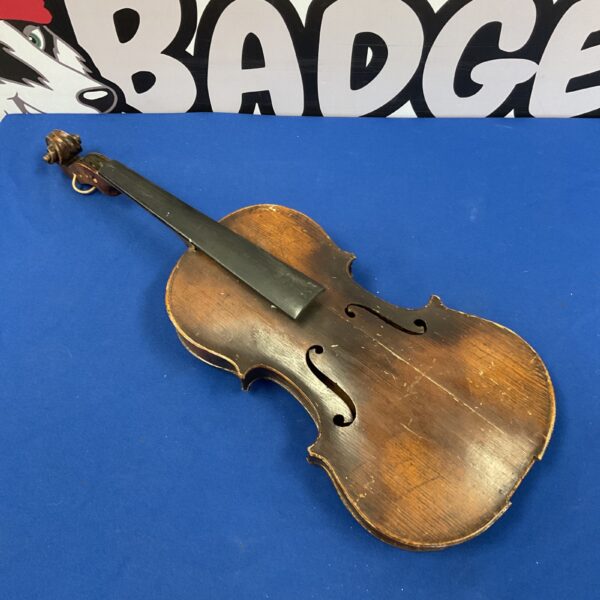 Front view of a vintage Stradivarius reproduction violin for restoration.