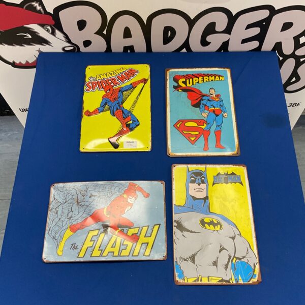 Set of four vintage superhero metal plates featuring Spiderman, Superman, Batman, and The Flash.