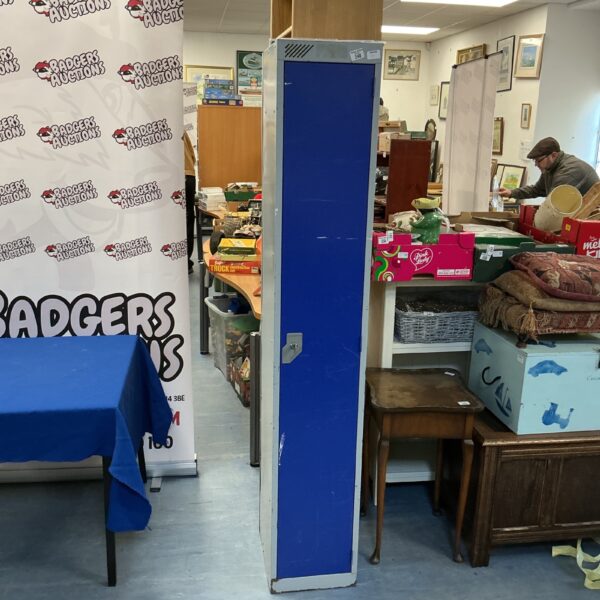 Tall vintage metal locker with key, ideal for storage and display.