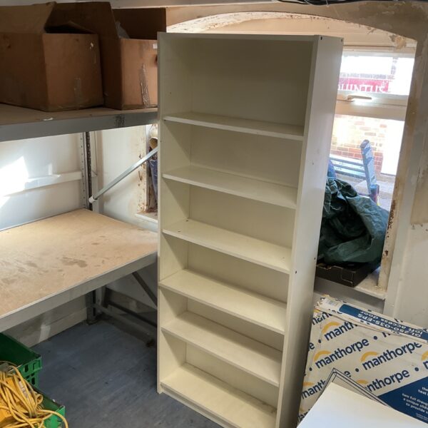 Tall white bookcase with multiple shelves, ideal for home storage.