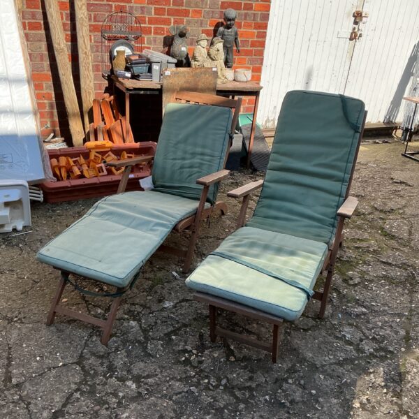 Pair of vintage teak garden sunloungers with cushions.