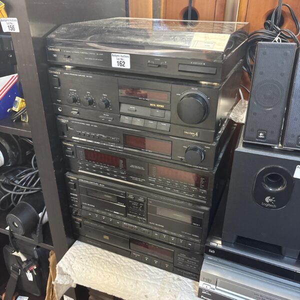 Vintage Technics hi-fi system components stacked together.