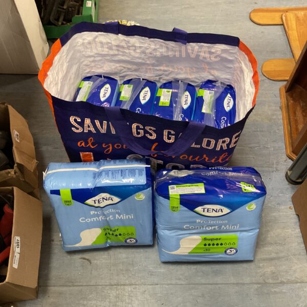 Bulk lot of Tena Comfort Mini Super incontinence pads for adult care.