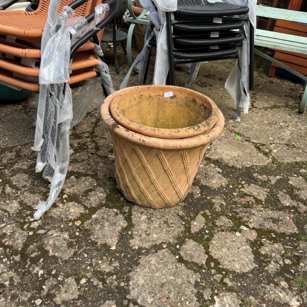 Vintage terracotta garden planter with weathered texture.