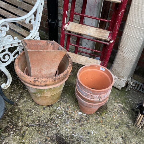 Vintage terracotta garden pots displayed outdoors, rustic garden decor.