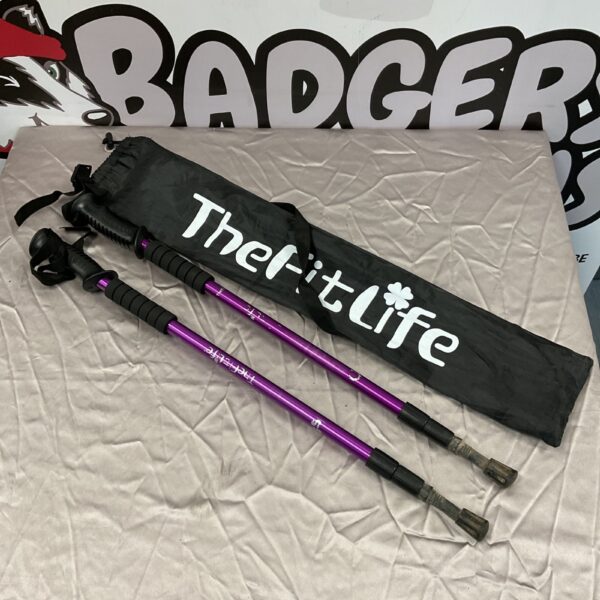 Pair of vibrant The Fit Life hiking sticks with protective covers.