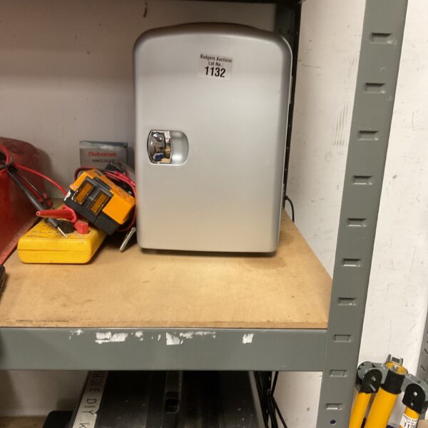 Side view of a portable thermoelectric mini fridge.