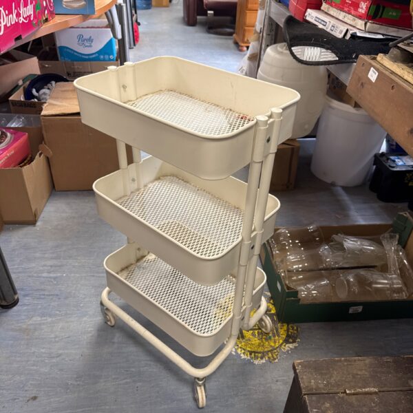 Three tier metal basket unit on wheels for storage.