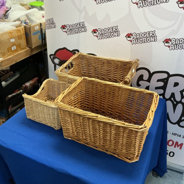 Three vintage wicker baskets for storage and display.